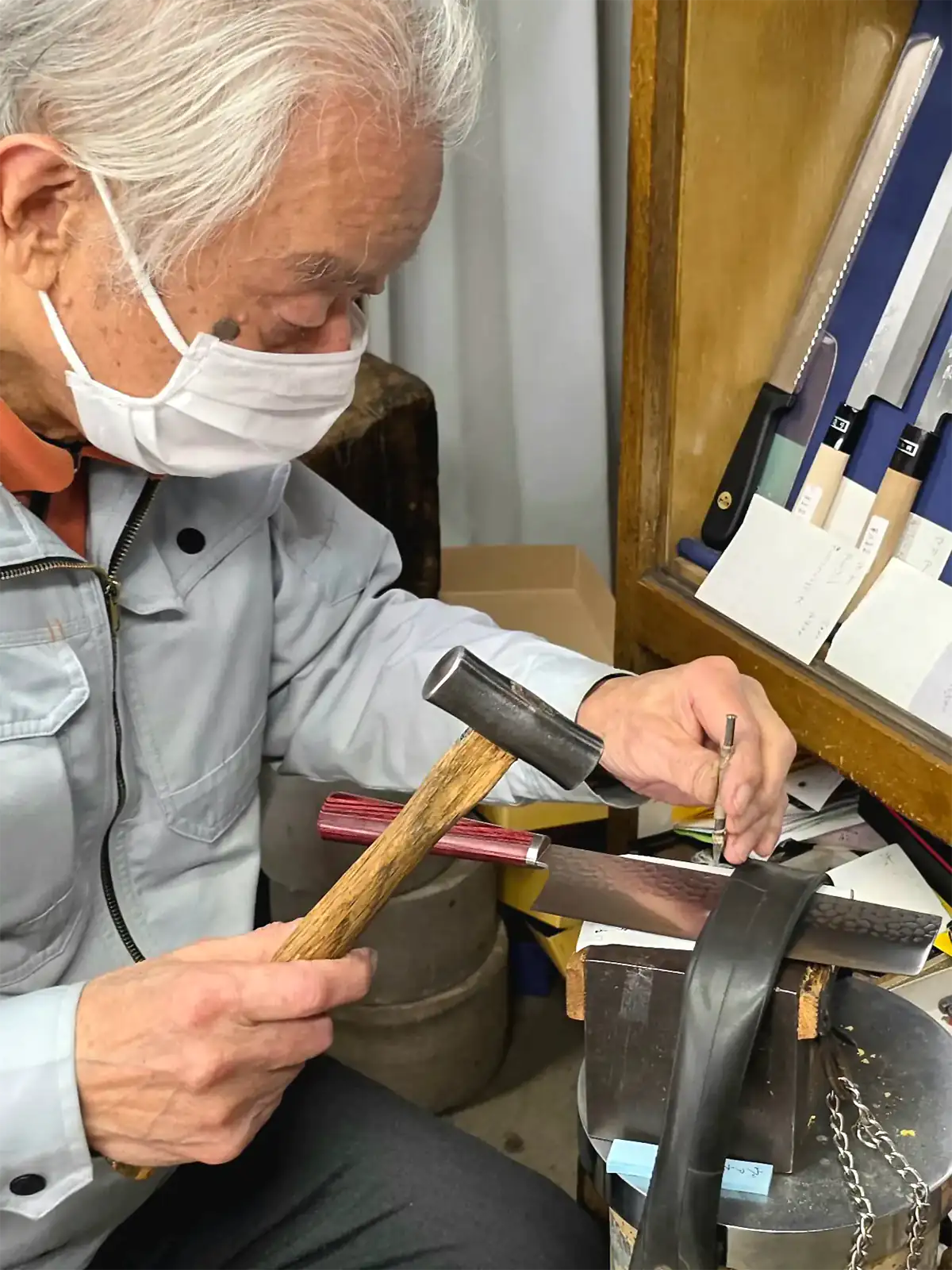 Hayakawa Masaya graviert mit Hammer und Punze einen Namen in ein japanisches Küchenmesser