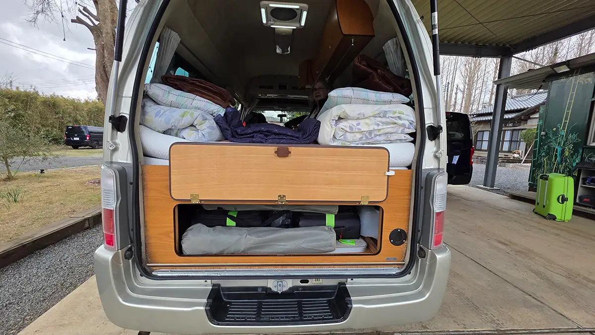 View into the tidy rear storage compartment of the Nissan Duo under the bed
