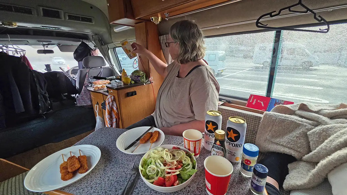 Cozy dinner at the dinette inside the Nissan Duo during rainy weather